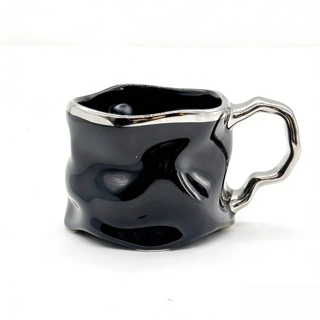 Ceramic cup with modern metallic handle design
