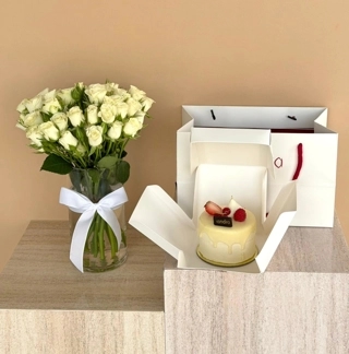 White vase with raspberry cake