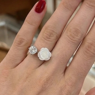 A luxurious ring made of mother-of-pearl, crystal, and silver.