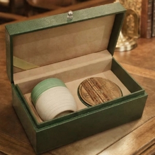 Artisan mug with a coaster featuring the Founding Day logo, inside a luxury box.