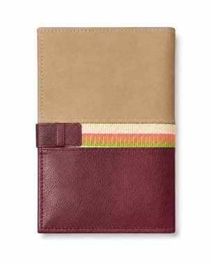 A handcrafted notebook folder decorated with hand-woven Sadu embroidery.