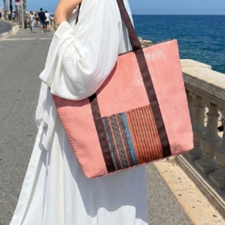A large bag made from premium recycled leather, embellished with heritage fabric.