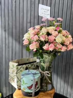 A vase of roses with Anoush's sweets