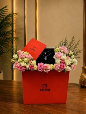 A bouquet of roses with a silver necklace