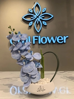 white vase with orchid arrangement