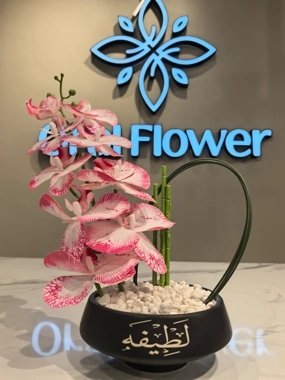Black vase with orchid arrangement