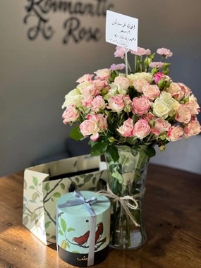 A vase of roses with Anoush's sweets